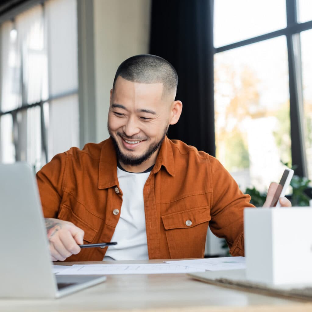 Business owner smiling at laptop